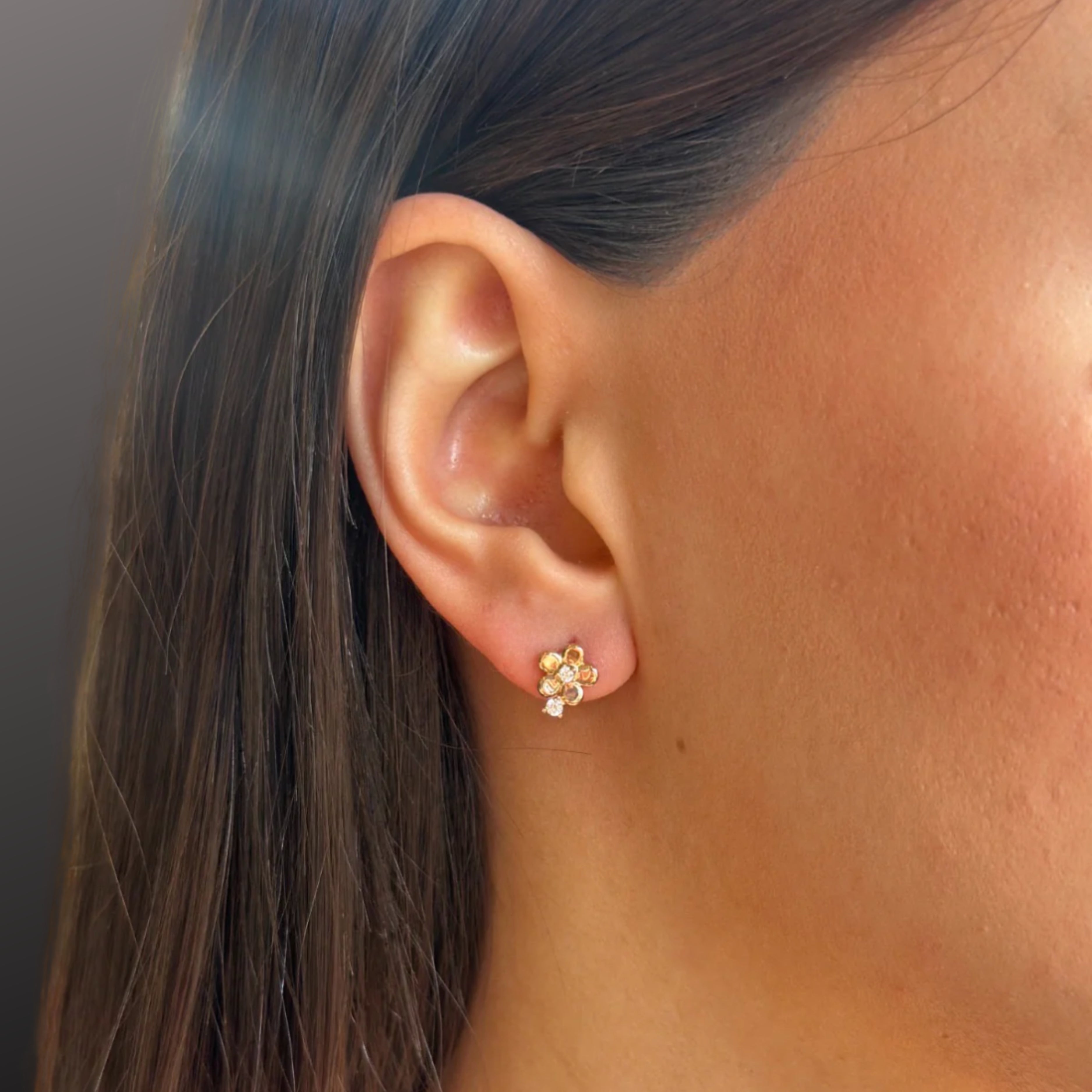 Náušnice CREYO FLOREA v tvare jemného kvetu so zirkónmi sú vyrobené zo 14K žltého zlata.